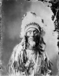 Lakota. Wears a fringed shirt, scarves over his braids1900s.jpg